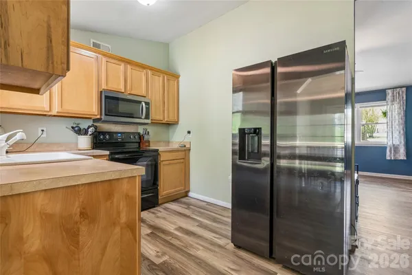 a kitchen with a refrigerator a stove and a kitchen island