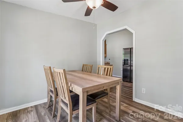 a view of a dining room with furniture and wooden floor