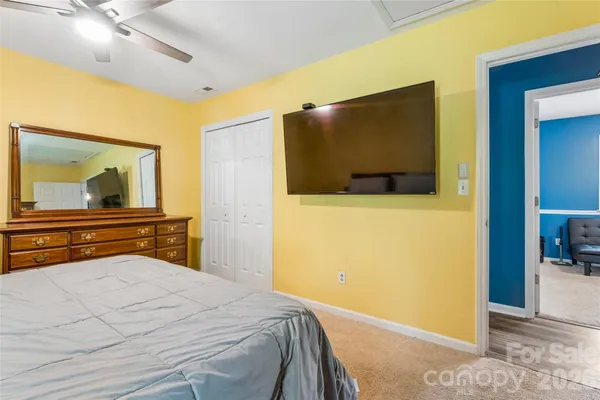 a bedroom with a bed and a flat screen tv
