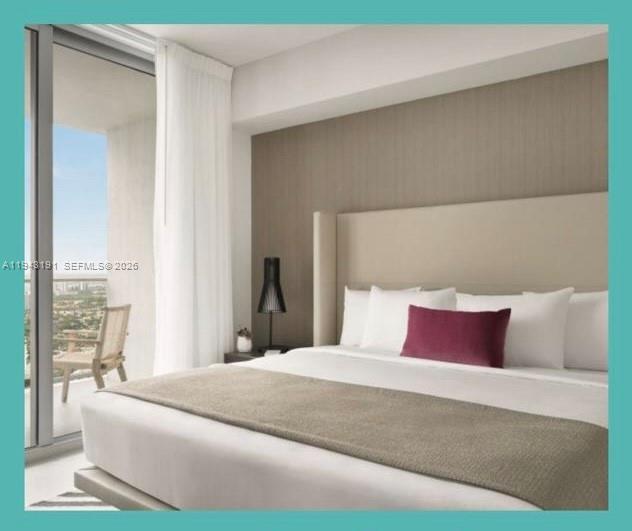 4010 South Ocean Drive, Unit R3004 Hollywood, FL 33019 - Photo 4 of 11 a bedroom with a large bed and a large mirror