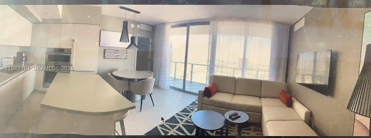 4010 South Ocean Drive, Unit R3004 Hollywood, FL 33019 - Photo 5 of 11 a living room with furniture and a large window