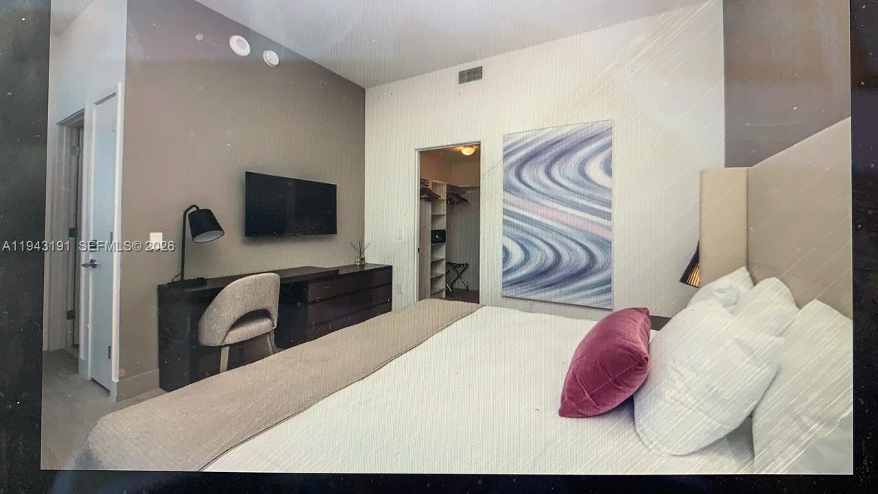 4010 South Ocean Drive, Unit R3004 Hollywood, FL 33019 - Photo 8 of 11 a bedroom with a bed and a flat screen tv