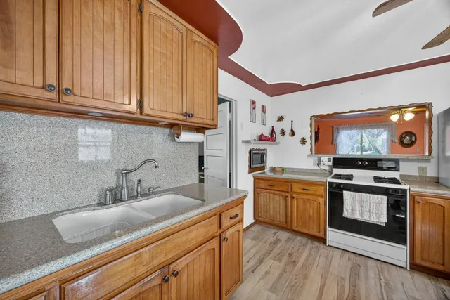 a kitchen with stainless steel appliances granite countertop a sink and cabinets