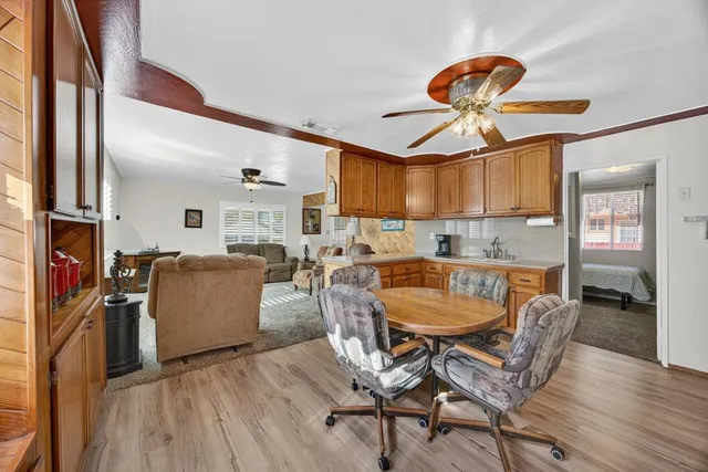 a dining room with furniture and wooden floor