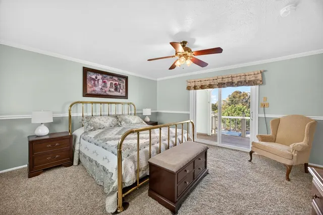 a bedroom with a bed a couch and a window