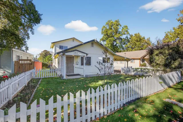a front view of a house with a garden