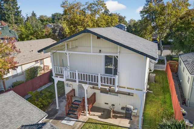 a view of a house with a yard and furniture