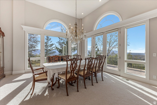 3222 Eagle View Circle Sandy, UT 84092 - Photo 10 of 60 Dining room with a chandelier, light carpet, and a high ceiling