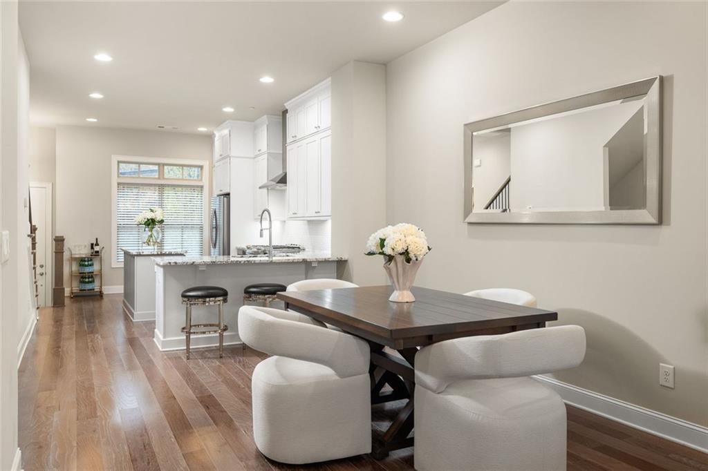 4751 Roswell Road Atlanta, GA 30342 - Photo 11 of 36 a kitchen with a table chairs and a wooden floor