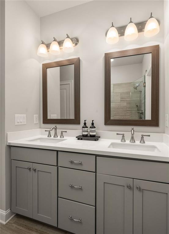 4751 Roswell Road Atlanta, GA 30342 - Photo 19 of 36 a bathroom with double vanity sinks and a mirror