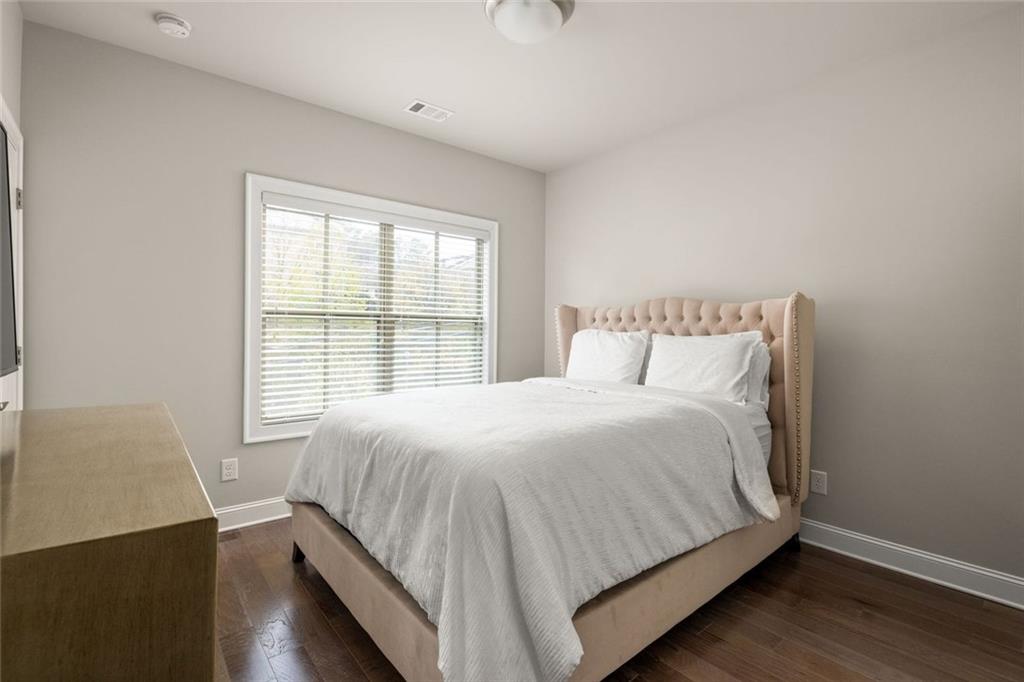 4751 Roswell Road Atlanta, GA 30342 - Photo 22 of 36 a large bed sitting in a bedroom next to a window