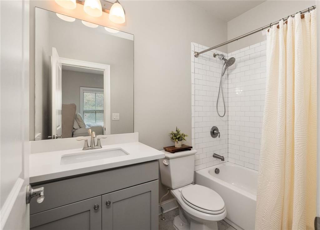 4751 Roswell Road Atlanta, GA 30342 - Photo 23 of 36 a bathroom with a sink toilet and shower