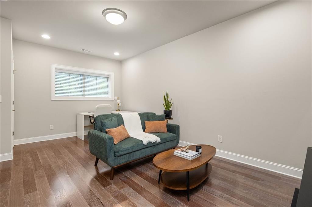 4751 Roswell Road Atlanta, GA 30342 - Photo 26 of 36 a living room with furniture and a wooden floor