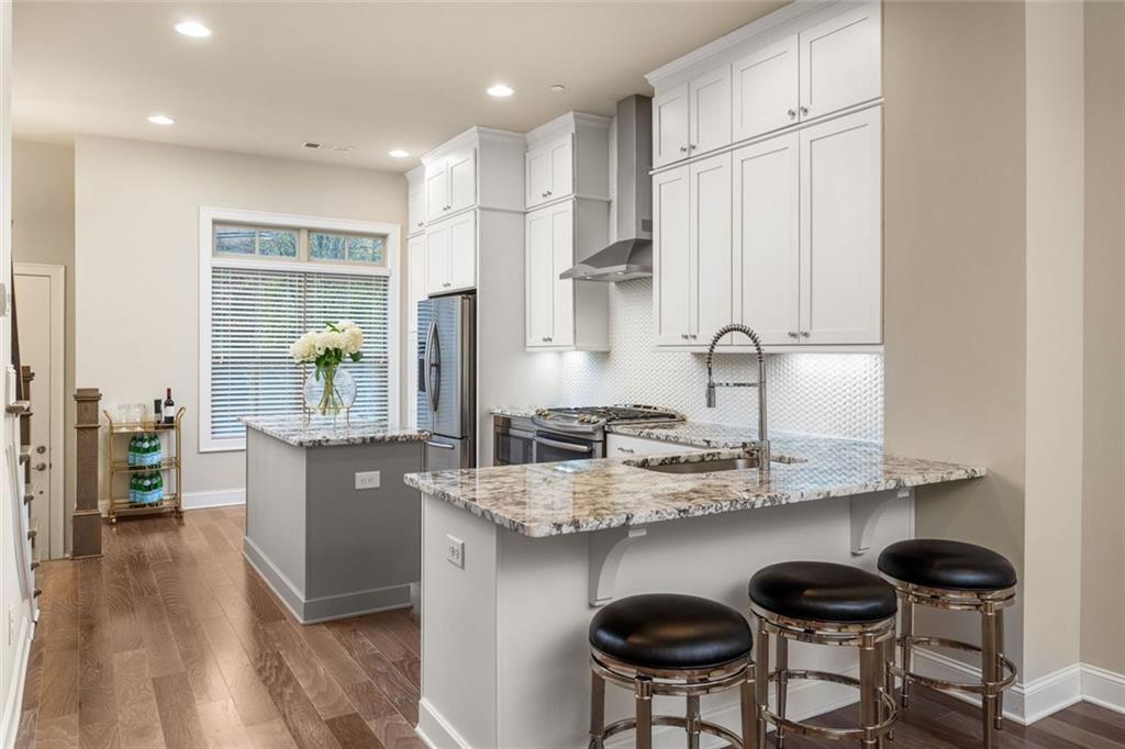 4751 Roswell Road Atlanta, GA 30342 - Photo 7 of 36 a kitchen with kitchen island granite countertop a sink and cabinets