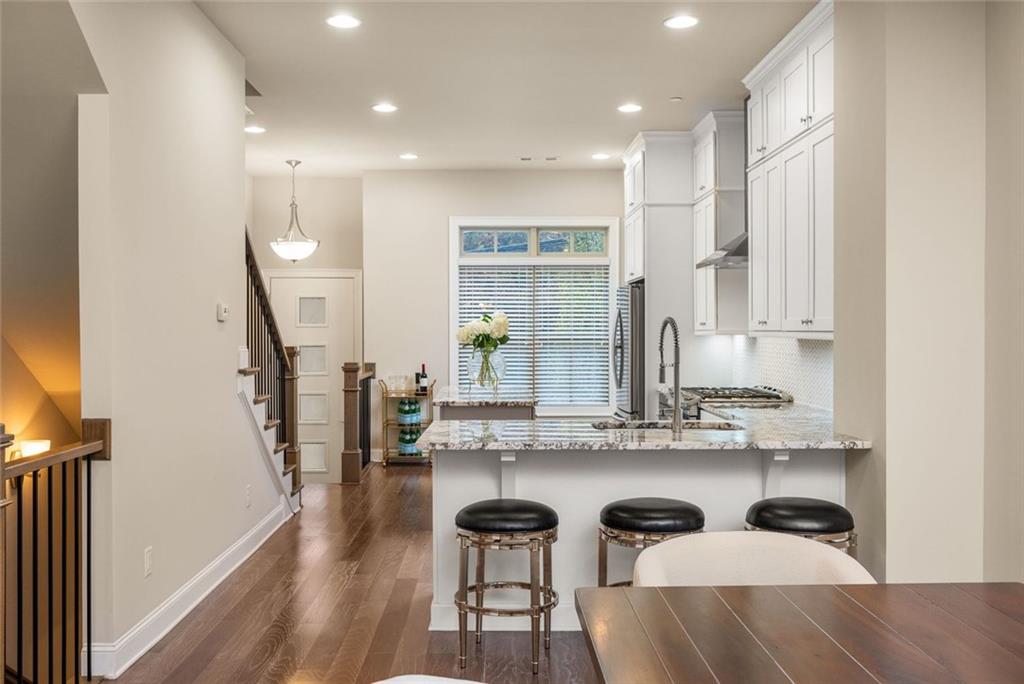 4751 Roswell Road Atlanta, GA 30342 - Photo 8 of 36 a kitchen with stainless steel appliances kitchen island granite countertop a stove a sink and a refrigerator