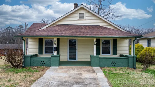 a front view of house with a garden