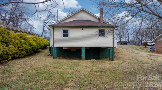 a view of a house with a yard and a garage