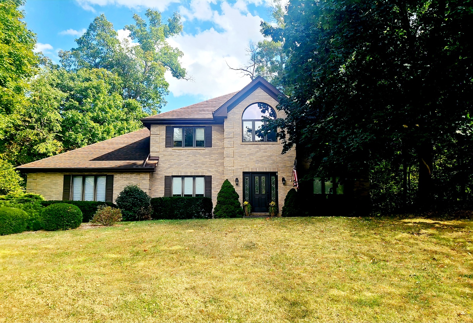 a front view of a house with a yard