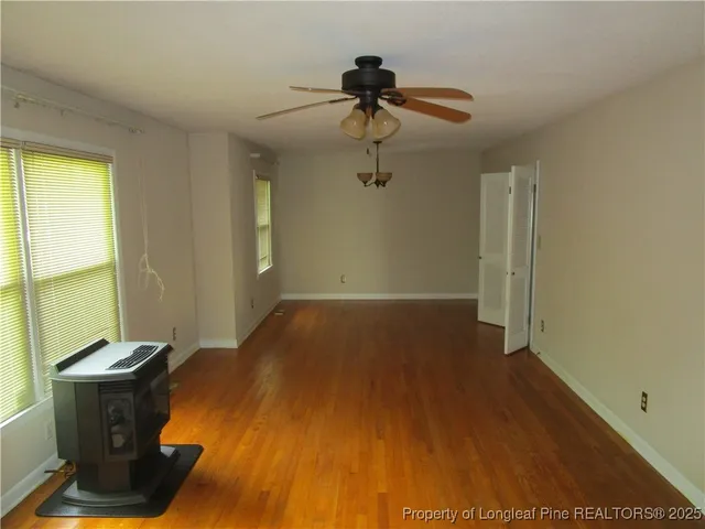 a view of a room with wooden floor and windows