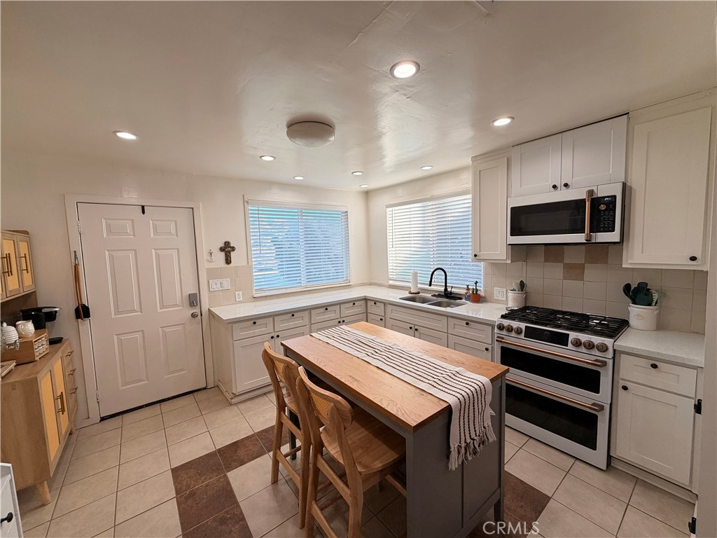 a kitchen with a stove a sink and a refrigerator