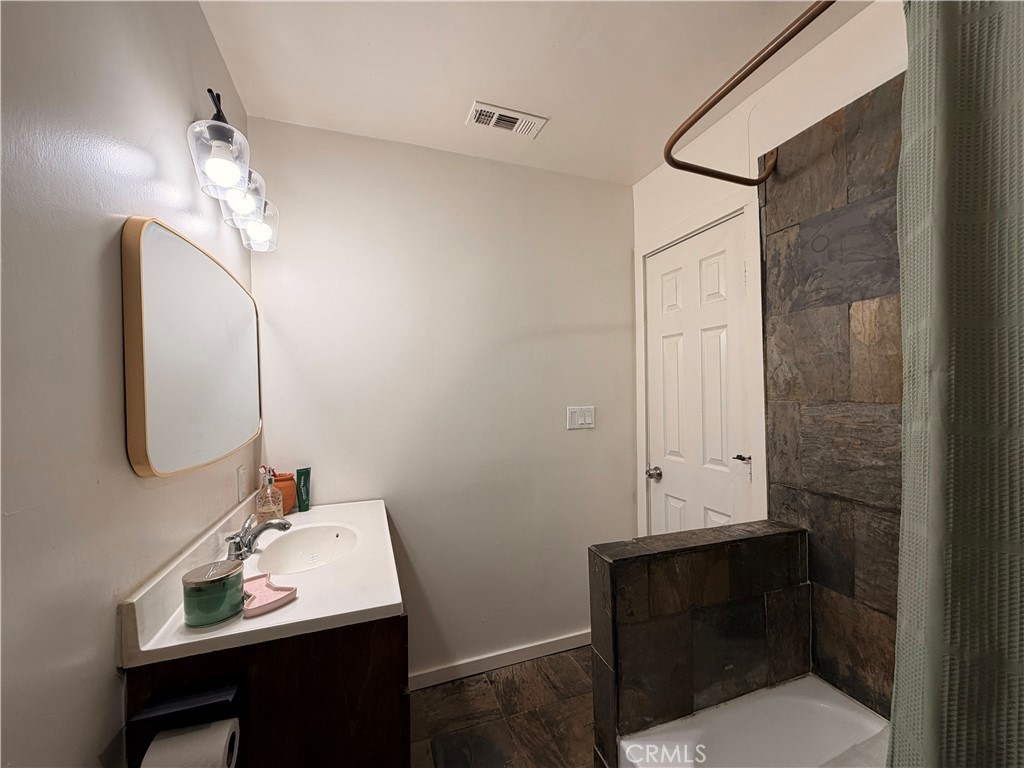 30009 Hunstock Street Castaic, CA 91384 - Photo 12 of 23 a bathroom with a sink vanity and a mirror