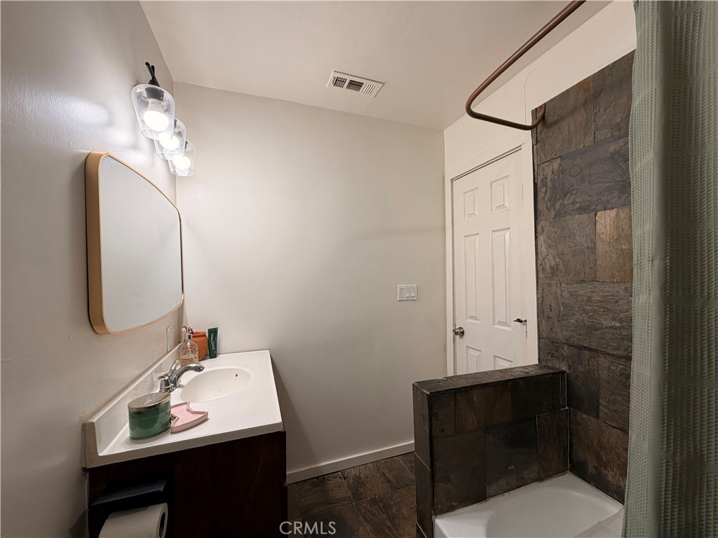 30009 Hunstock Street Castaic, CA 91384 - Photo 19 of 23 a bathroom with a sink vanity and a mirror