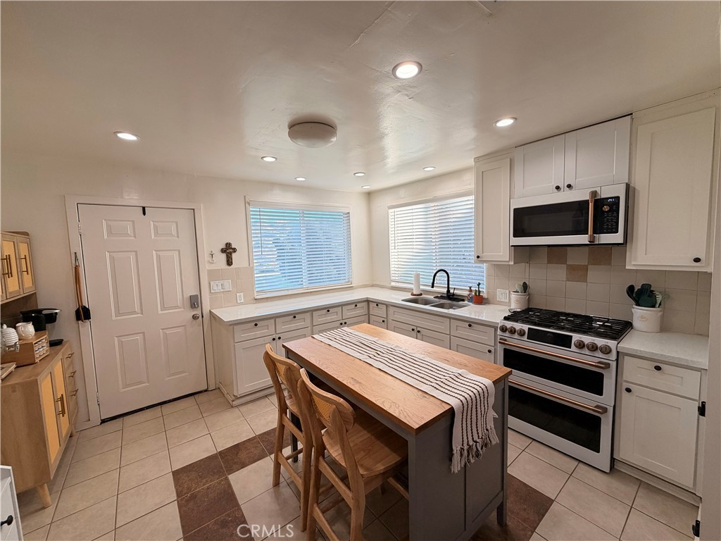 30009 Hunstock Street Castaic, CA 91384 - Photo 7 of 23 a kitchen with a stove a sink and a refrigerator