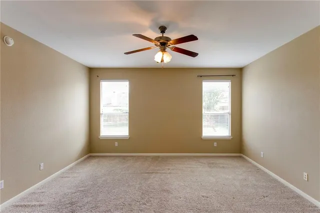 a spacious bathroom with a tub sink and mirror