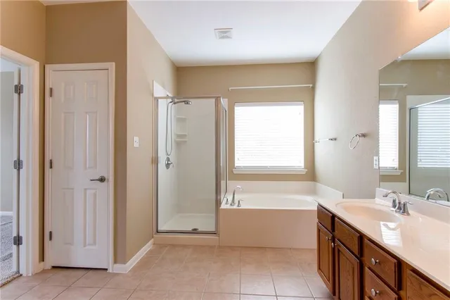 a white bath tub sitting in a bathroom next to a window