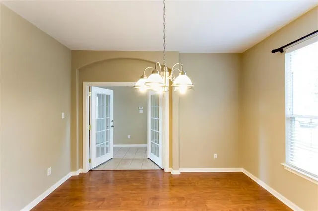a view of a livingroom with a chandelier fan and a window