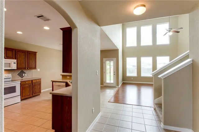a view of an empty room with a fireplace and a window