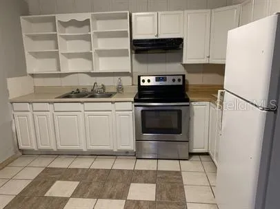 a kitchen with a stove and a refrigerator