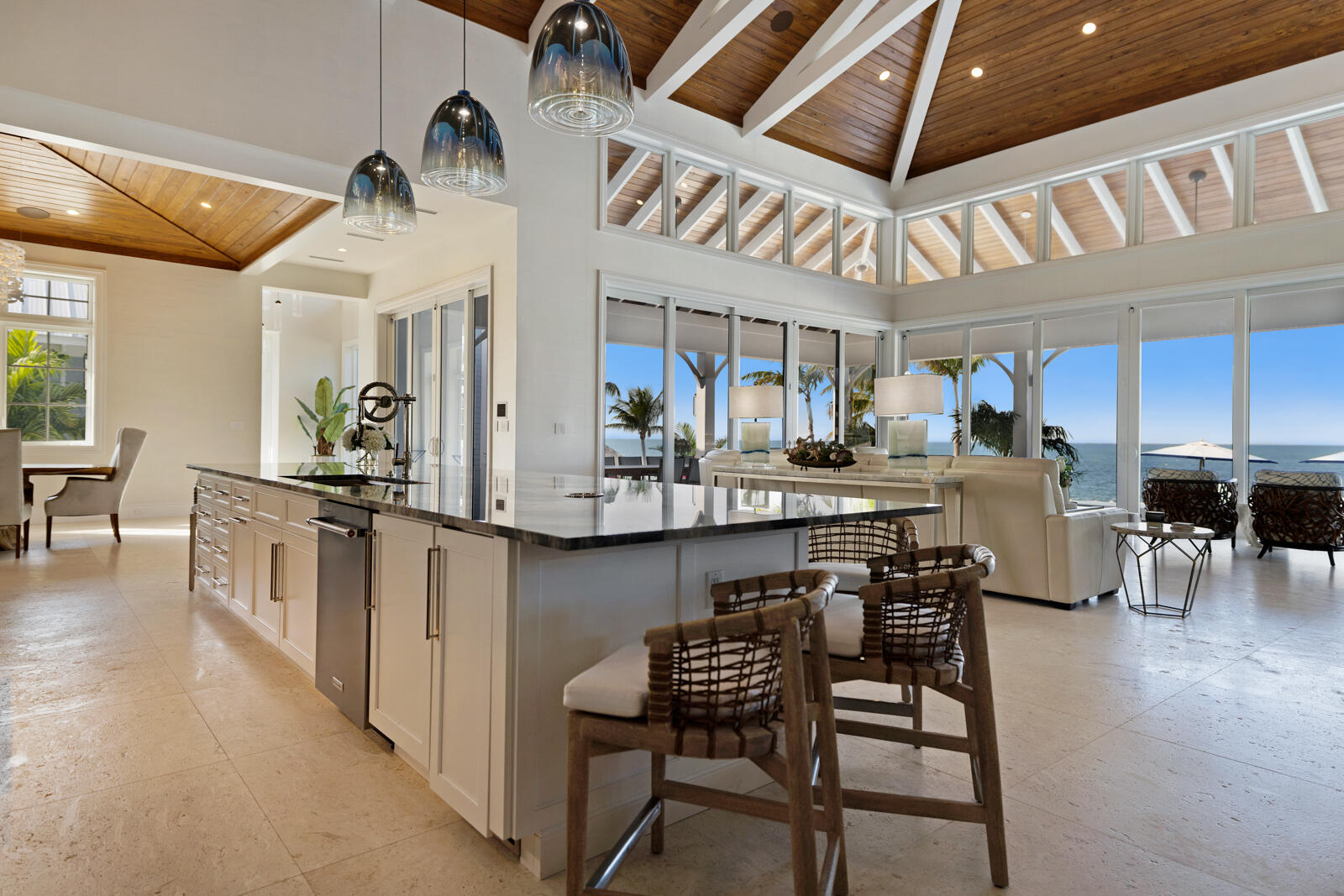 a kitchen with stainless steel appliances kitchen island granite countertop a table chairs stove a sink and dishwasher