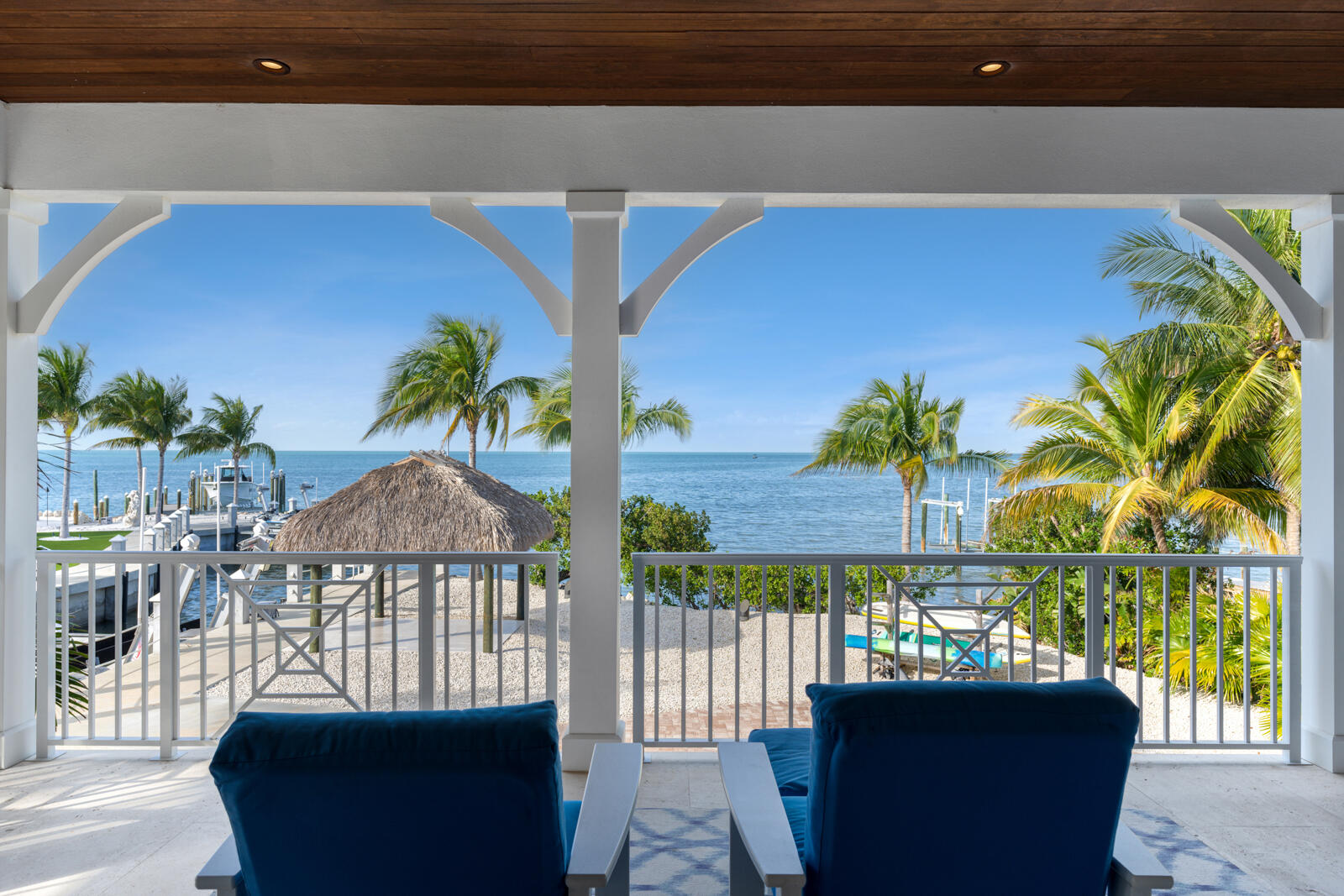 57223 Morton Street Marathon, FL 33050 - Photo 100 of 159 a view of a patio with couches table and chairs under an umbrella