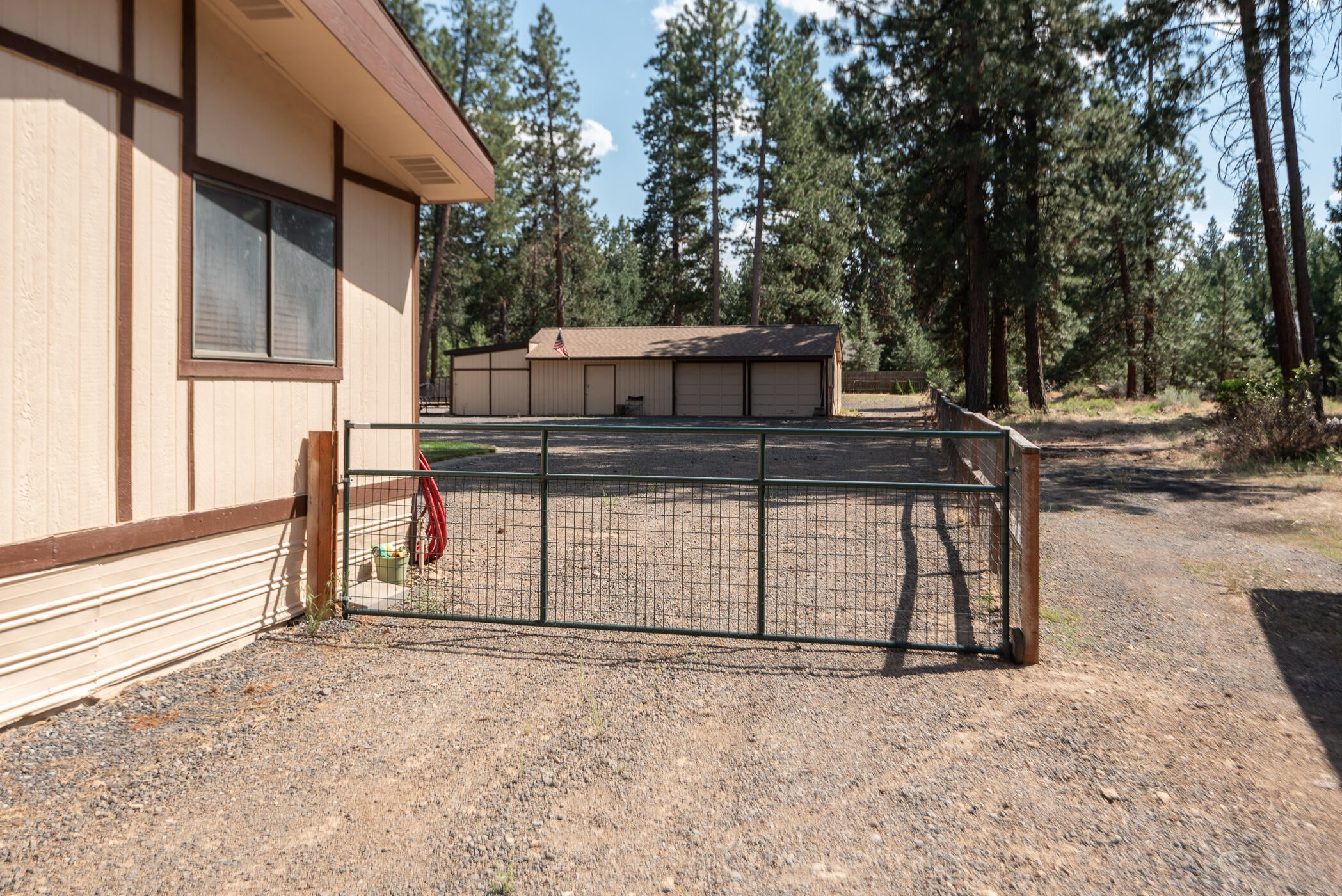 19245 Apache Road Bend, OR 97702 - Photo 25 of 33 gate allows vehicles to drive to shop
