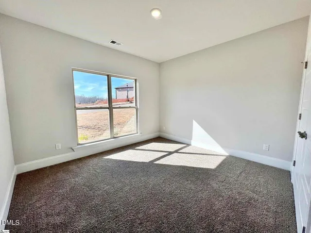 a bathroom with a bathtub shower sink vanity mirror and toilet