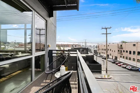 a spacious bedroom with a bed and glass door