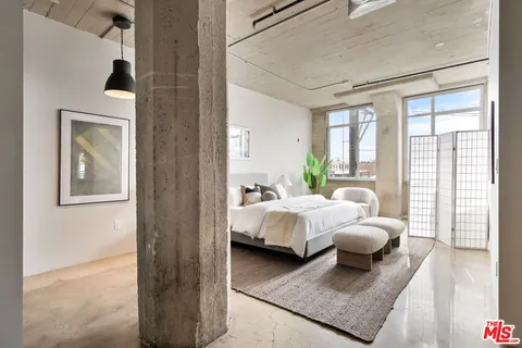 a bedroom with bed and a couch