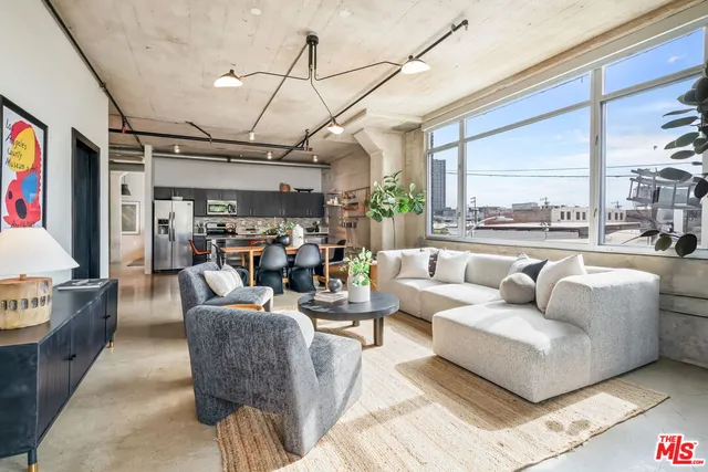 a living room with furniture large window and a table