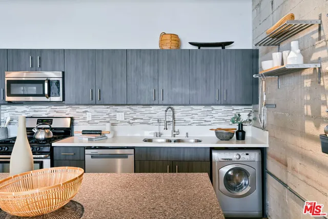 a kitchen with a sink a stove and cabinets