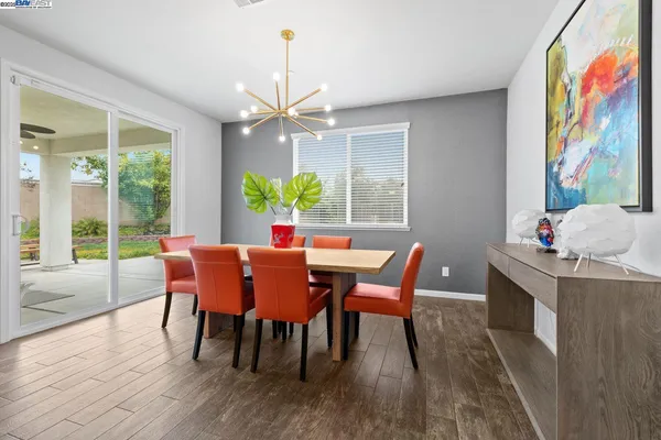 a view of a backyard with couches plants and wooden fence