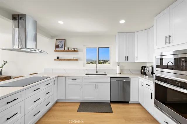 a kitchen with a sink stove and cabinets