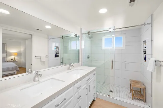 a bathroom with a double vanity sink mirror double shower and a bathtub