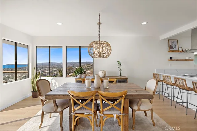 a dining room with furniture a chandelier and wooden floor