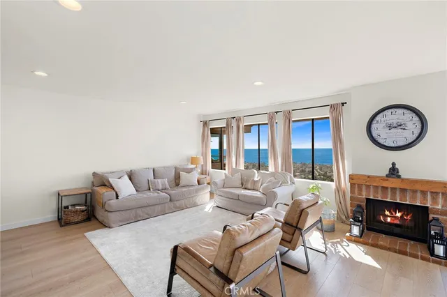 a living room with furniture a clock and a large window