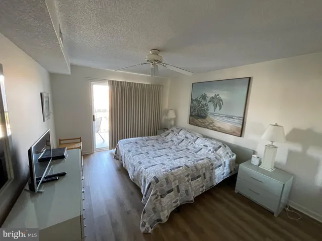 a bedroom with a bed flat screen tv and window