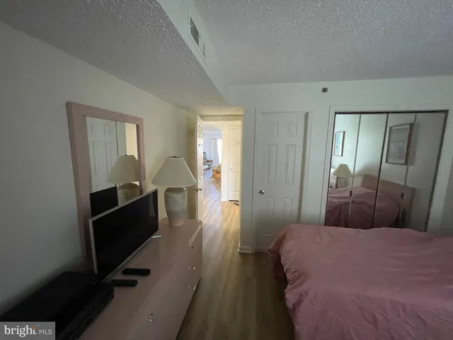 a bedroom with a bed and a mirror