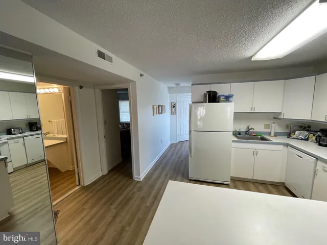 a kitchen with a refrigerator a sink and cabinets