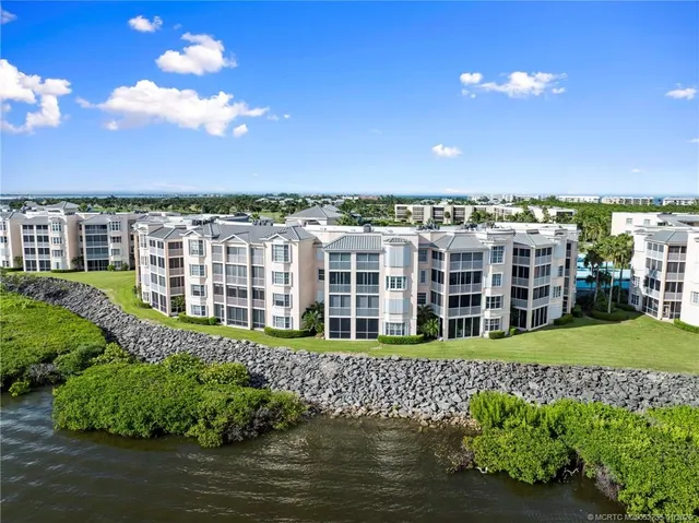 a large building with a big yard and plants