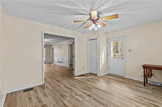 wooden floor in an empty room with a window
